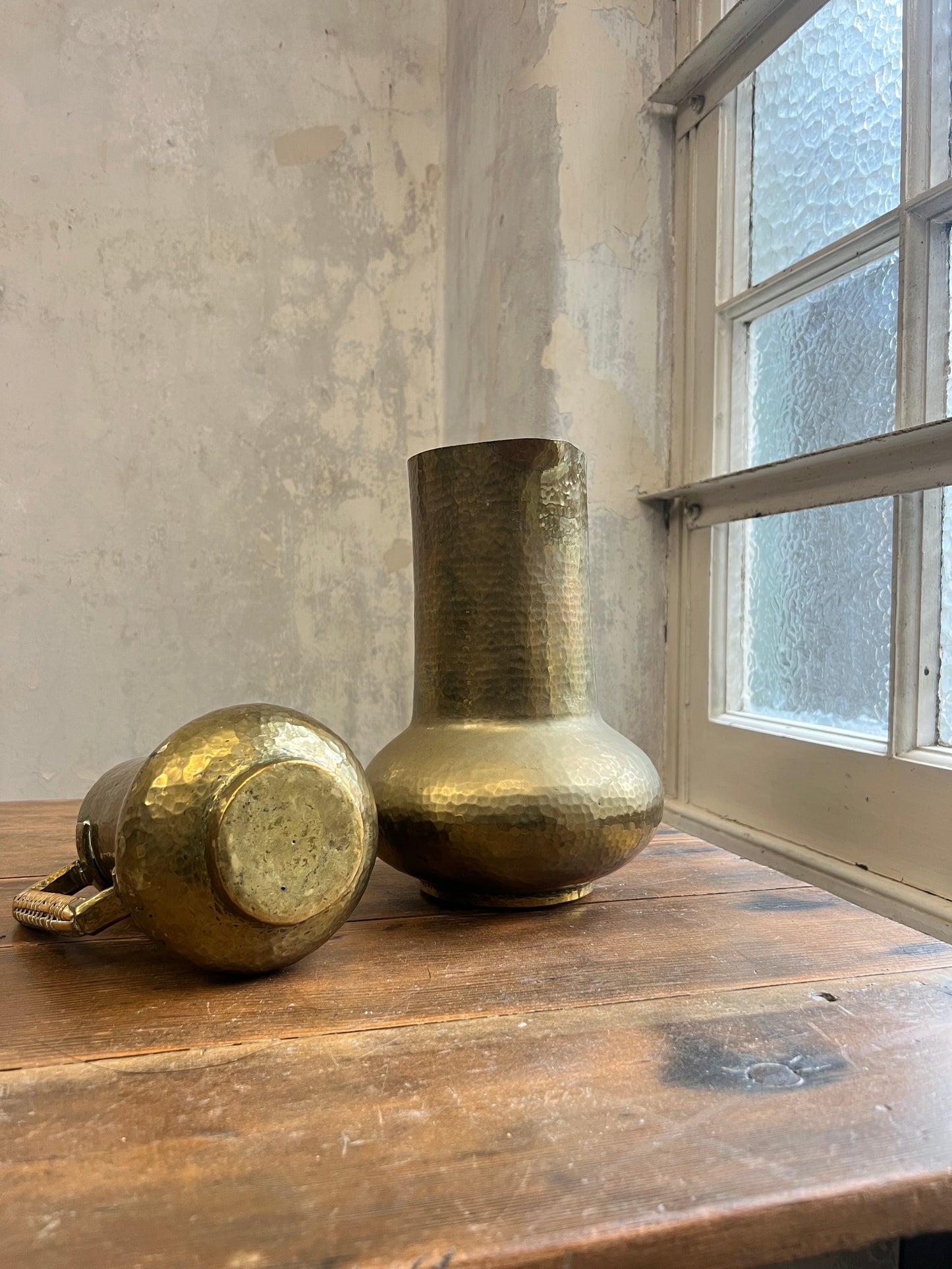 Two Graduating Arts and Crafts Brass Pitchers