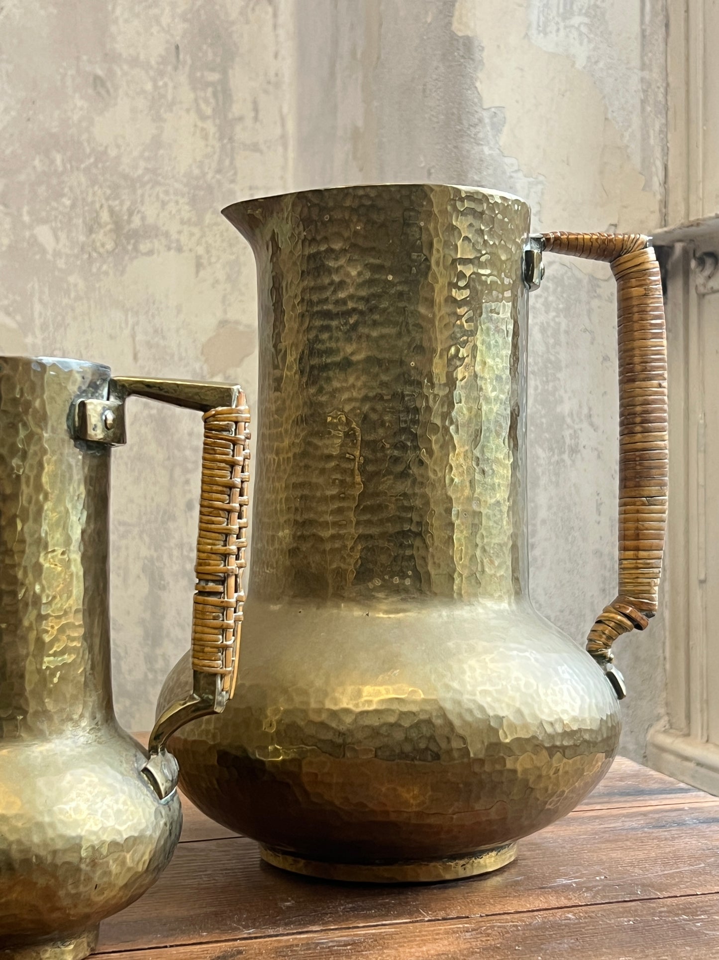 Two Graduating Arts and Crafts Brass Pitchers