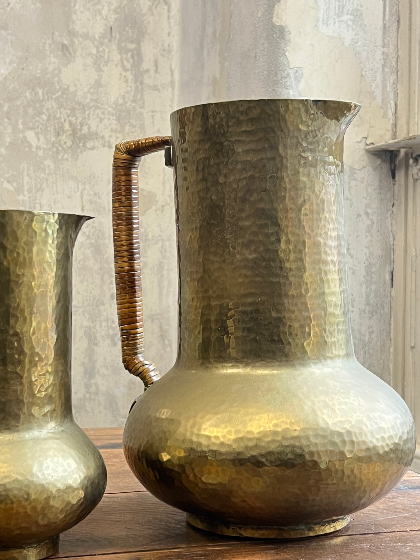 Two Graduating Arts and Crafts Brass Pitchers