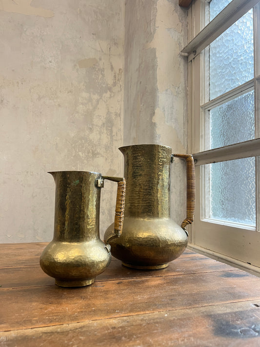Two Graduating Arts and Crafts Brass Pitchers