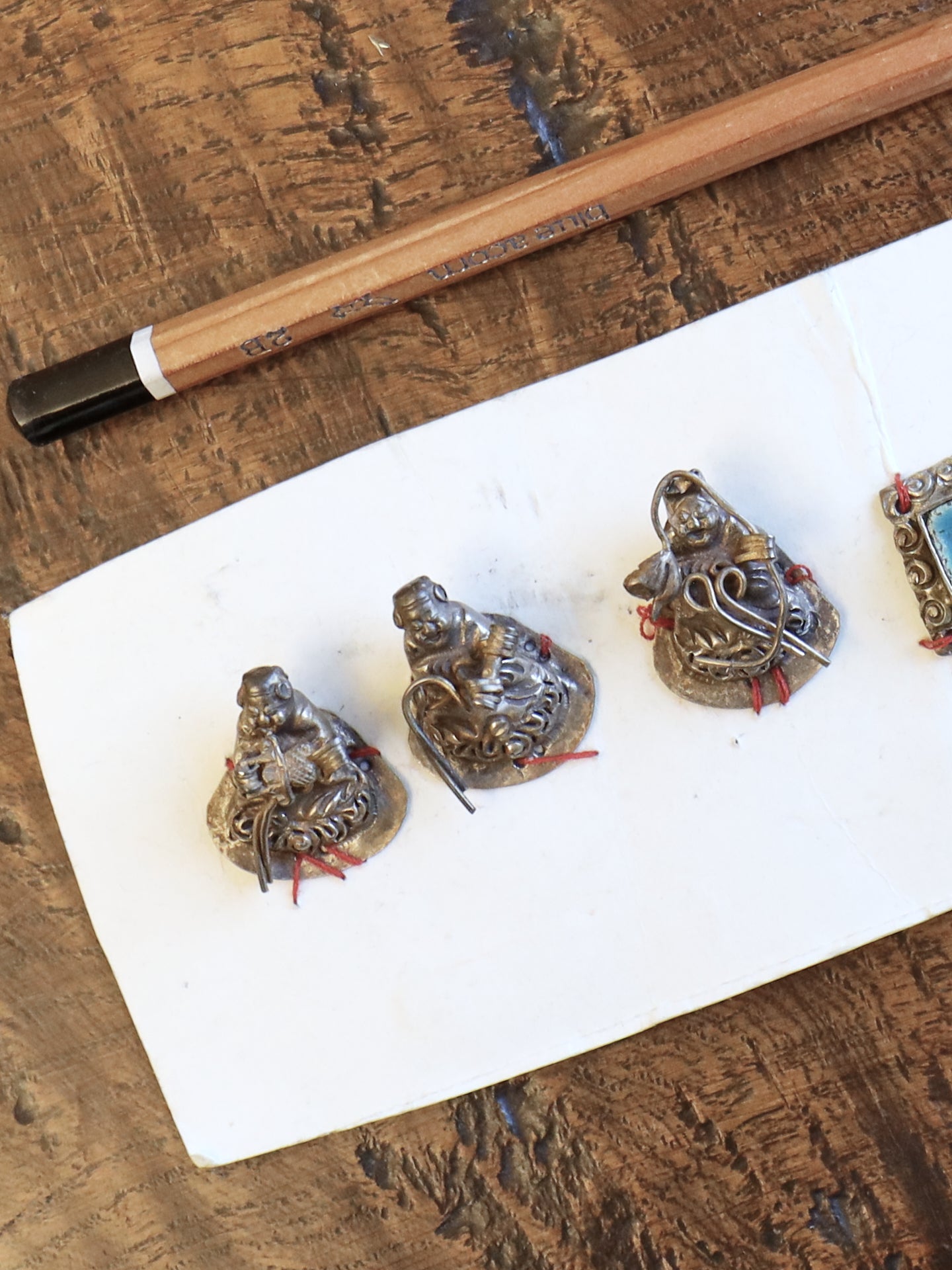 A Set of Seven Chinese Figurine Hat Ornaments