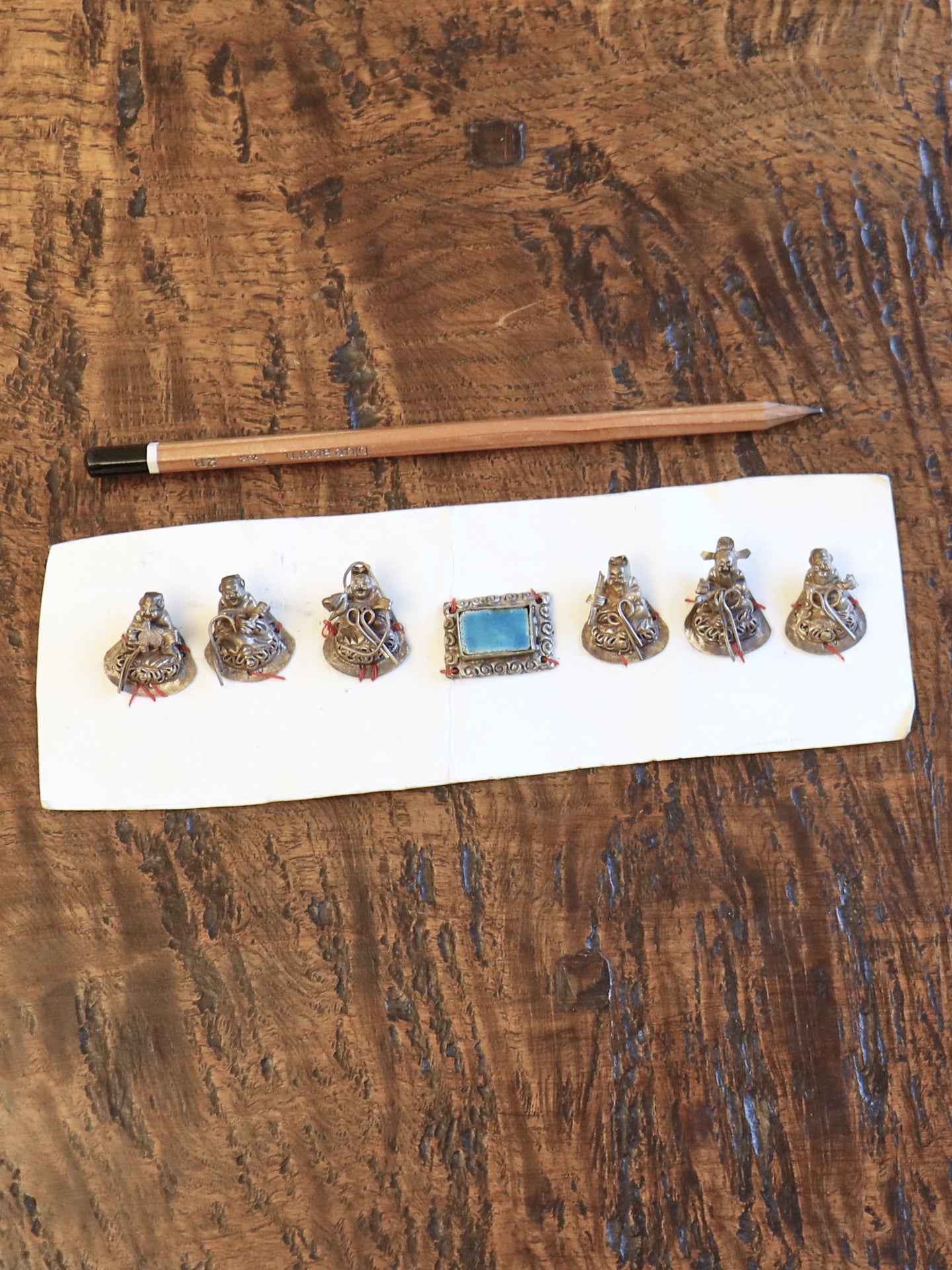 A Set of Seven Chinese Figurine Hat Ornaments